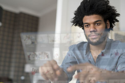 Man at home working on futuristic screen