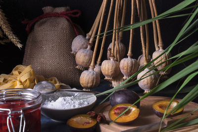 Long angle close-up of sweet pasta dessert, noodles with poppy seeds on dark background table.