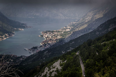 Scenic view of sea and mountains against sky