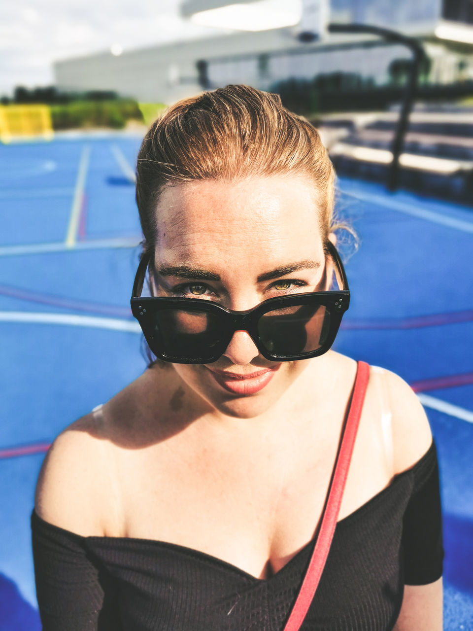 portrait, one person, front view, headshot, real people, lifestyles, sunglasses, leisure activity, young adult, glasses, focus on foreground, fashion, young women, smiling, day, looking at camera, security, swimming pool, hairstyle, beautiful woman