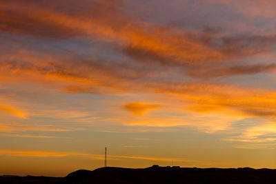 Low angle view of dramatic sky during sunset