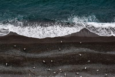 Aerial view of waves rushing towards shore