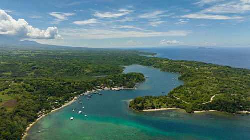 Top view of bay with boats on the background of mountains. negros, philippines.
