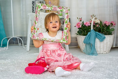 Portrait of cute girl sitting on floor