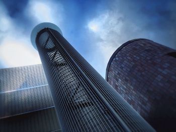 Low angle view of modern building against cloudy sky