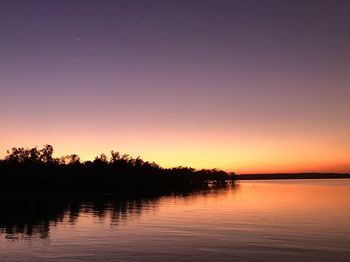 Scenic view of lake against romantic sky at sunset