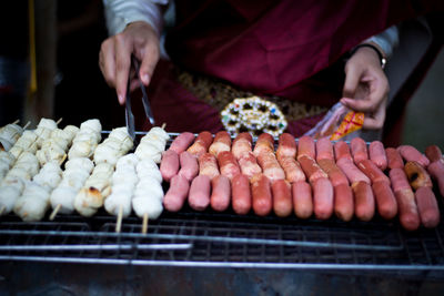 Midsection of man preparing food at market stall