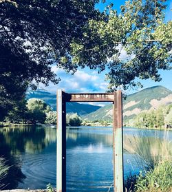 Arch bridge over lake against sky