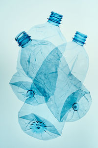 High angle view of plastic bottle against colored background