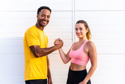 Portrait of smiling friends exercising at home