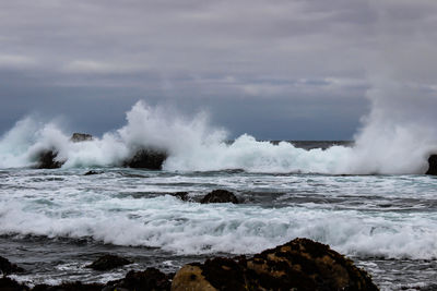 Waves breaking against sea