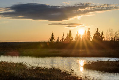 Scenic view of lake against sky during sunset