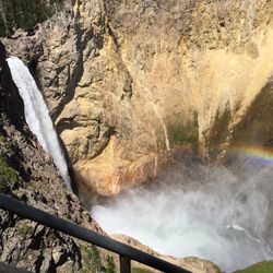 Scenic view of waterfall against sky