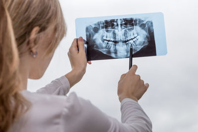 Midsection of woman looking at camera