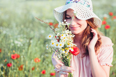 Teenage girl smelling flowers