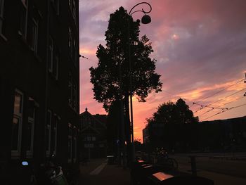 Street light against cloudy sky at sunset