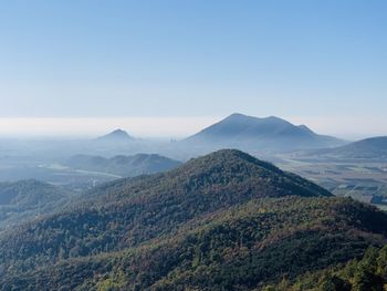 Scenic view of mountains and hills against clear sky