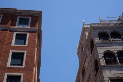 Low angle view of building against clear blue sky