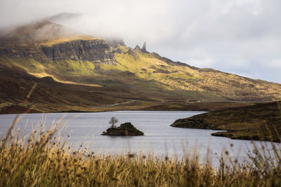 Scenic view of lake and mountains against sky