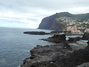 Scenic view of sea and mountains against sky