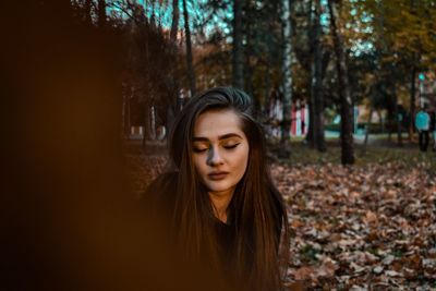 Portrait of beautiful young woman in autumn