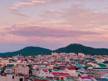 High angle shot of townscape against sky at sunset