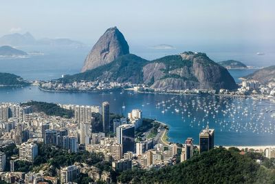 High angle view of cityscape with sugarloaf mountain against sky