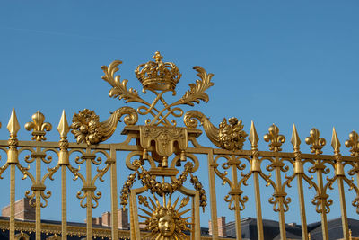 Low angle view of sculpture against blue sky