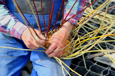 Midsection of man holding straws