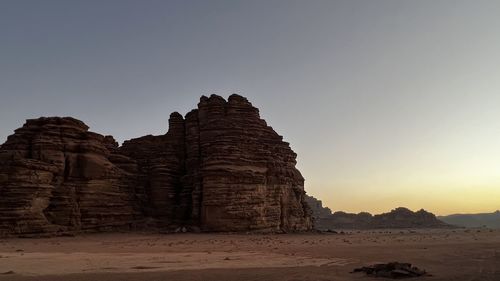 Built structure on rocks against clear sky