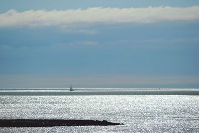 Scenic view of sea against cloudy sky