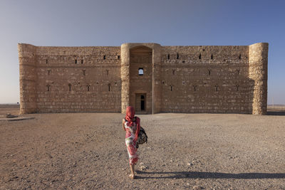 Woman in front of a building