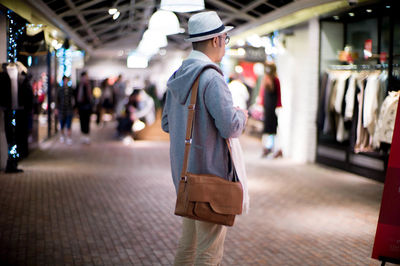 Man standing in shopping mall at night