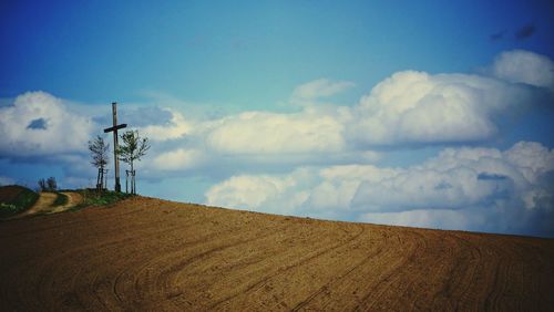 Low angle view of landscape against blue sky