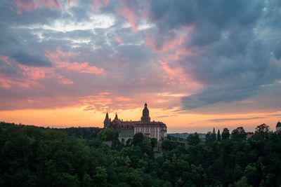 Traditional building against sky during sunset