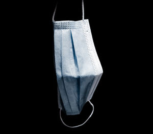 Close-up of clothes hanging over black background