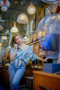 Woman using telephone at store