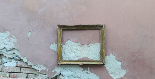 Close-up of weathered window on wall