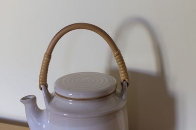 Close-up of teapot against wall