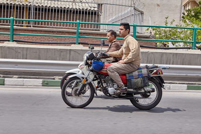 Man riding bicycle on motorcycle