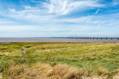 Bridge at sandy severn beach against sky