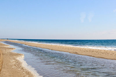 Scenic view of beach against clear sky