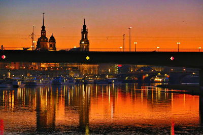 Illuminated buildings in water at night