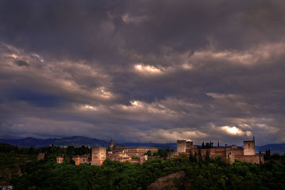 Alhambra palace against cloudy sky in stormy weather
