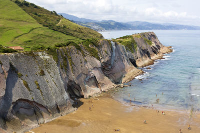 High angle view of rocks on beach against sky