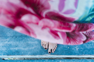 Low section of woman with pink umbrella