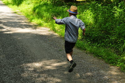 Full length of man running on road