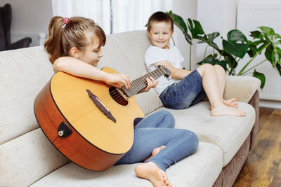 Boy playing guitar at home