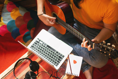 High angle view of man playing guitar