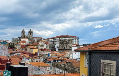 Buildings in town against sky